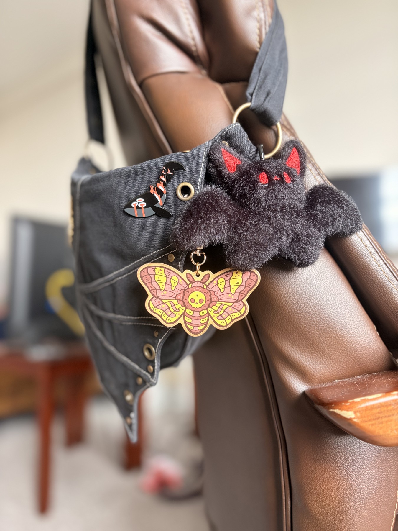 Whale pin, bat plush, and moth charm on my bag